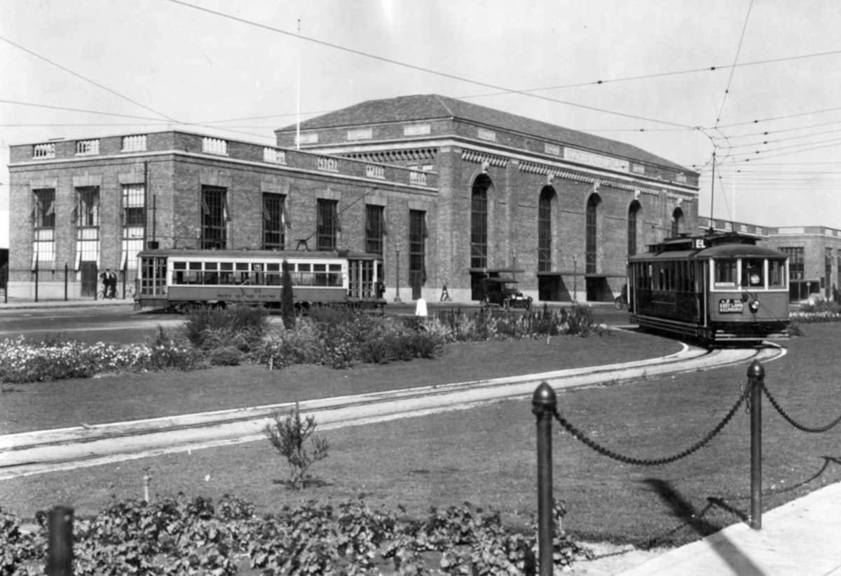 A black and white photo of the Sacramento Valley Station in 1926. Two trolley cars can be seen in the foreground.