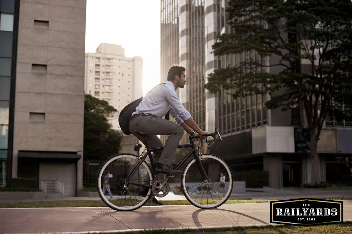 Image of a man riding a bike. Learn more about sustainable development at the Railyards.