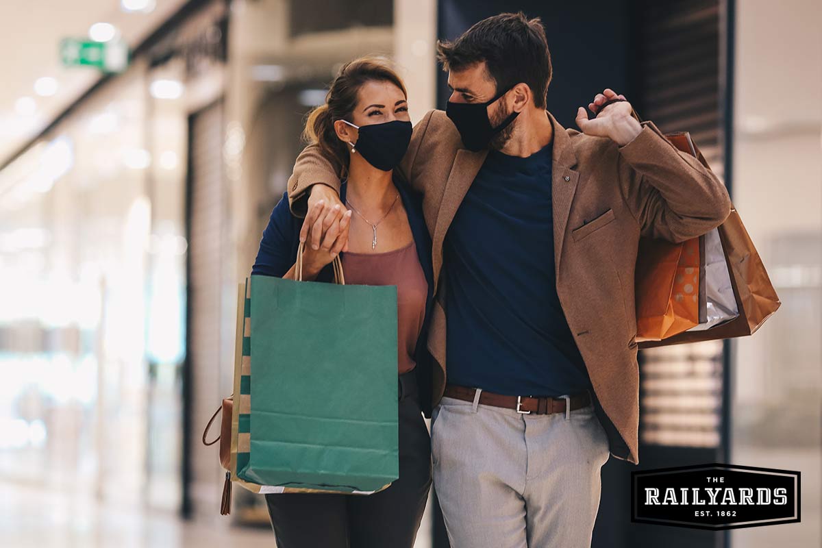 A young couple does their holiday shopping while wearing masks. Learn more about Sacramento COVID restrictions.